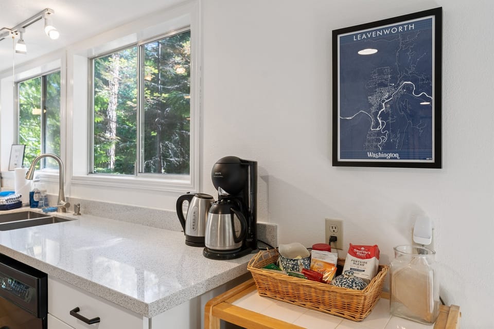 Coffee station with a drip coffee maker. Ground coffee, tea, hot chocolate, and cider are provided for guests!