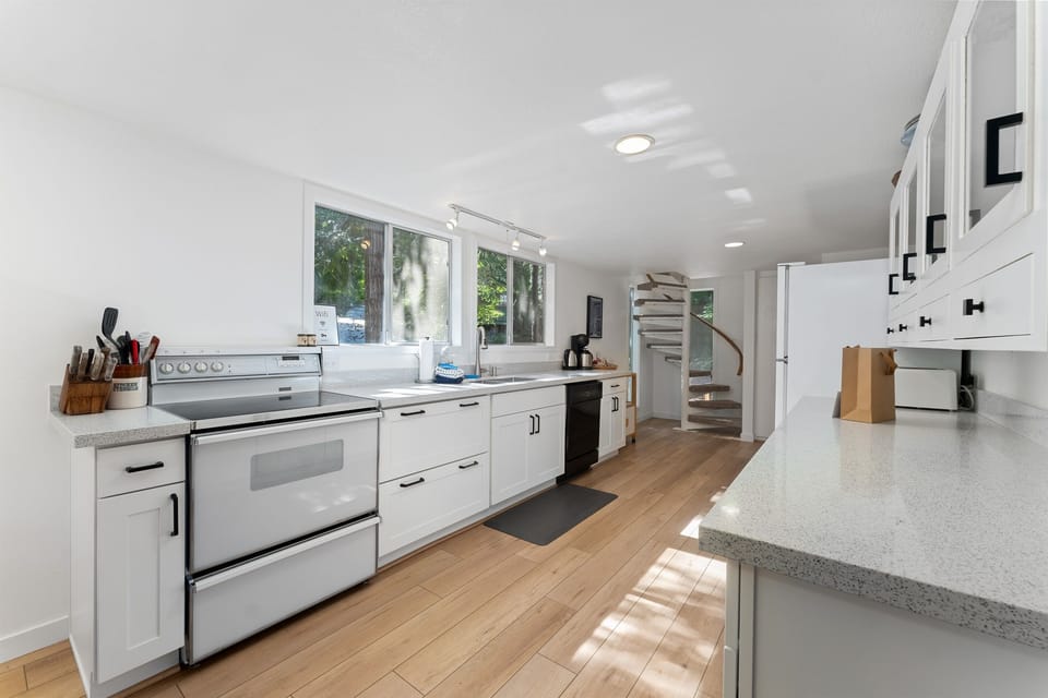 Stairs from kitchen provide access to loft bedrooms.
