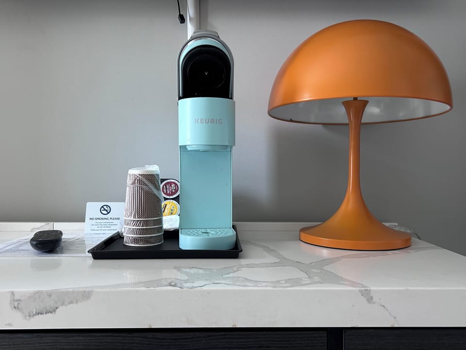 Desk, iron/ironing board, bed sheets