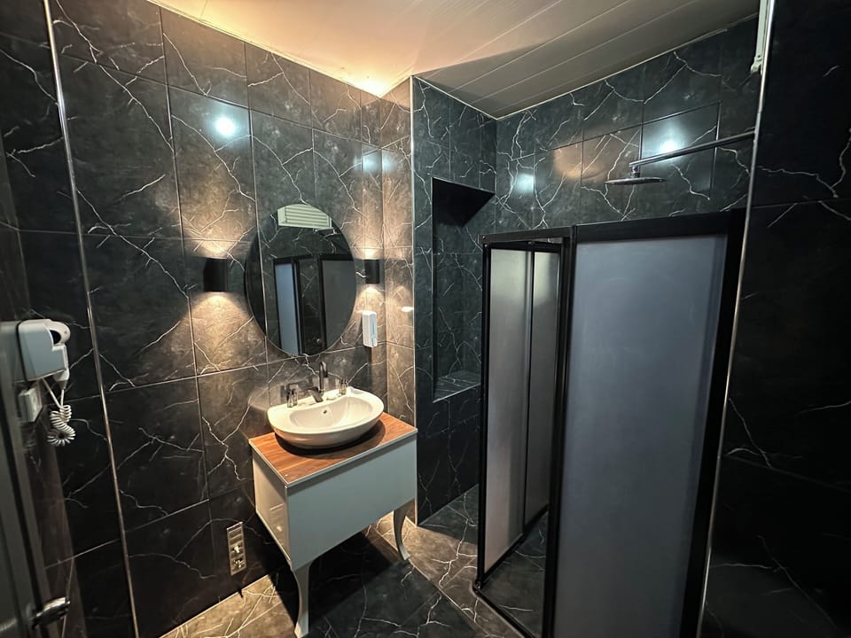 Designer toiletries, hair dryer, slippers, towels