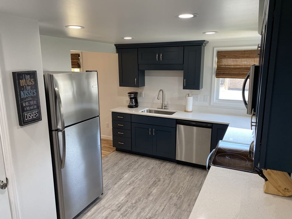 Kitchen view of stainless refrigerator