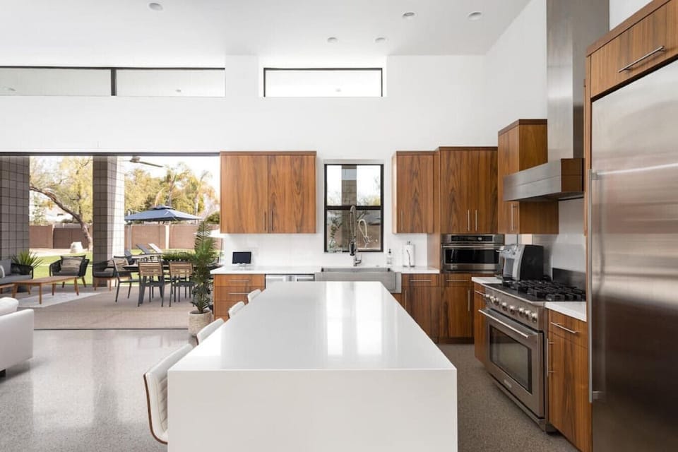 Cook and connect in this spacious Scottsdale kitchen with high-end appliances and open flow to the patio.