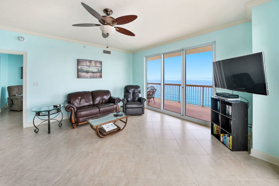 Sink into leather comfort while gazing at endless ocean views through floor-to-ceiling windows in your coastal living room.