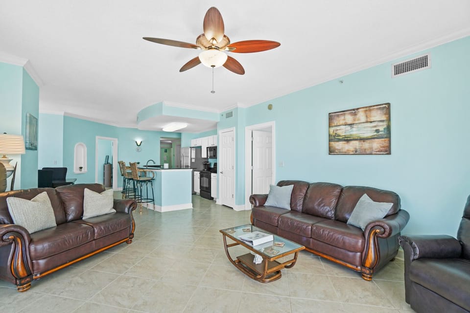 Unwind in your spacious living room with plush leather seating and tropical ceiling fan keeping you cool and comfortable.