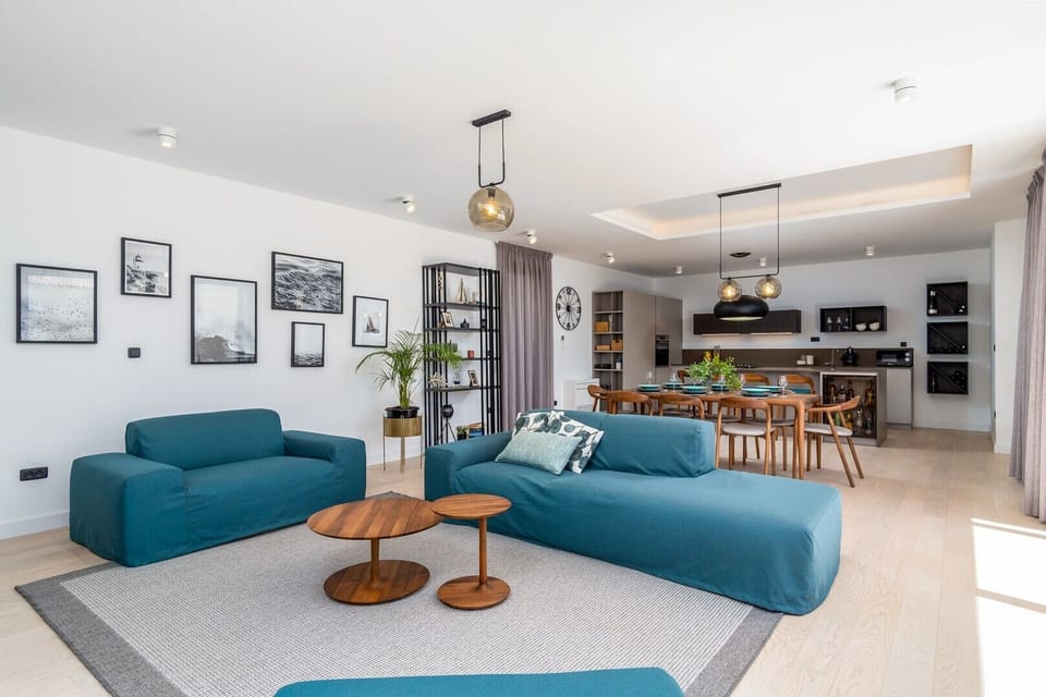 A spacious living room area with a flat-screen TV, PS5, free WiFi