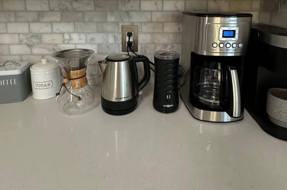 Complete coffe station, includes drip coffee maker, Keurig single pods, French Press, Chemex, hot water kettle, coffee bean grinder and milk frother.
