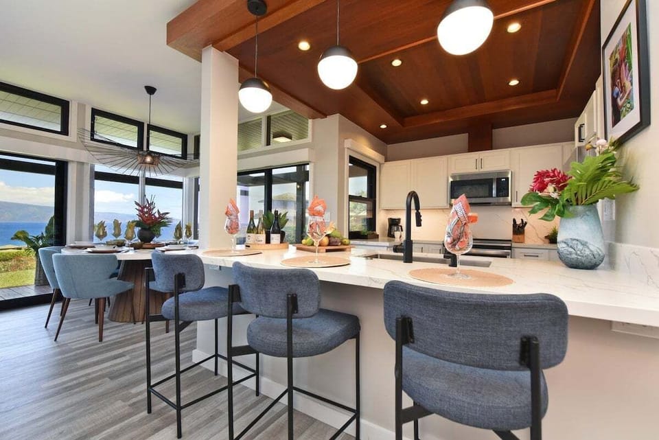 Fully remodeled kitchen with bar seating, modern appliances, and open layout.