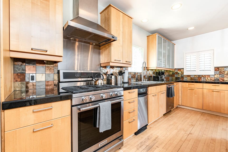 The kitchen comes stocked with dishes, utensils, bakeware, cookware, and large and small appliances.
                