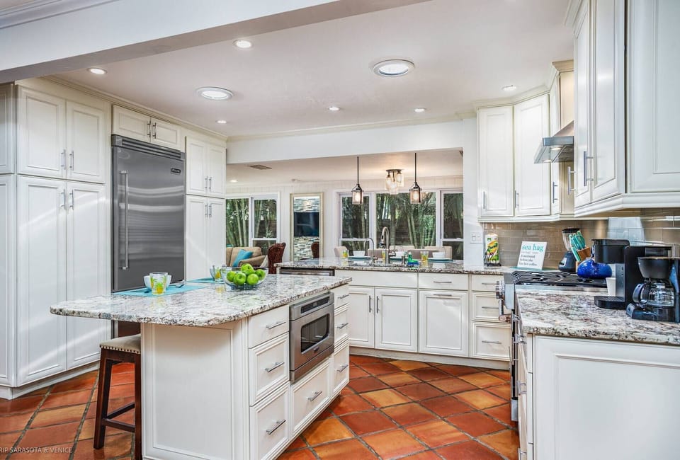 Custom built-in microwave within the granite island.  Island bar seating for two.