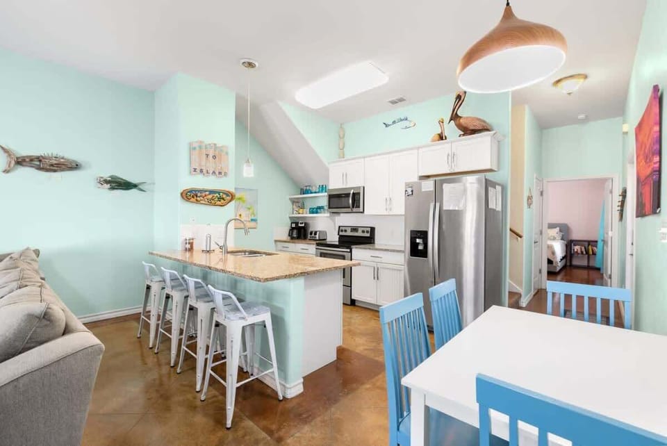 Kitchen & Dining — Granite Bar, White Stools, Pelican Decor, Blue Dining Table & Pendant Light