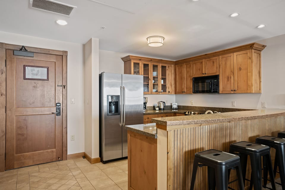 Countertop dining area with bar stools.
