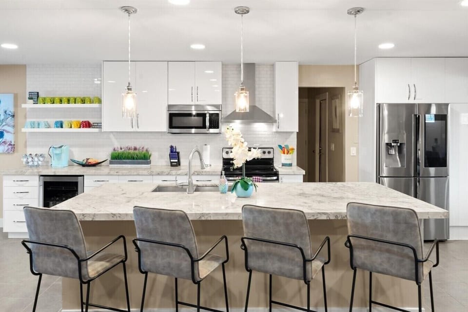 The perfect spot for pre-game drinks or brunch prep, featuring a massive island and wine fridge.