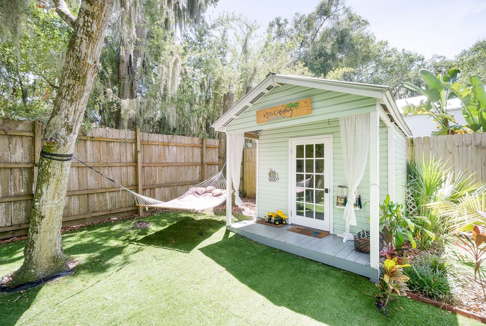 Kids backyard playhouse, with shady hammock.
