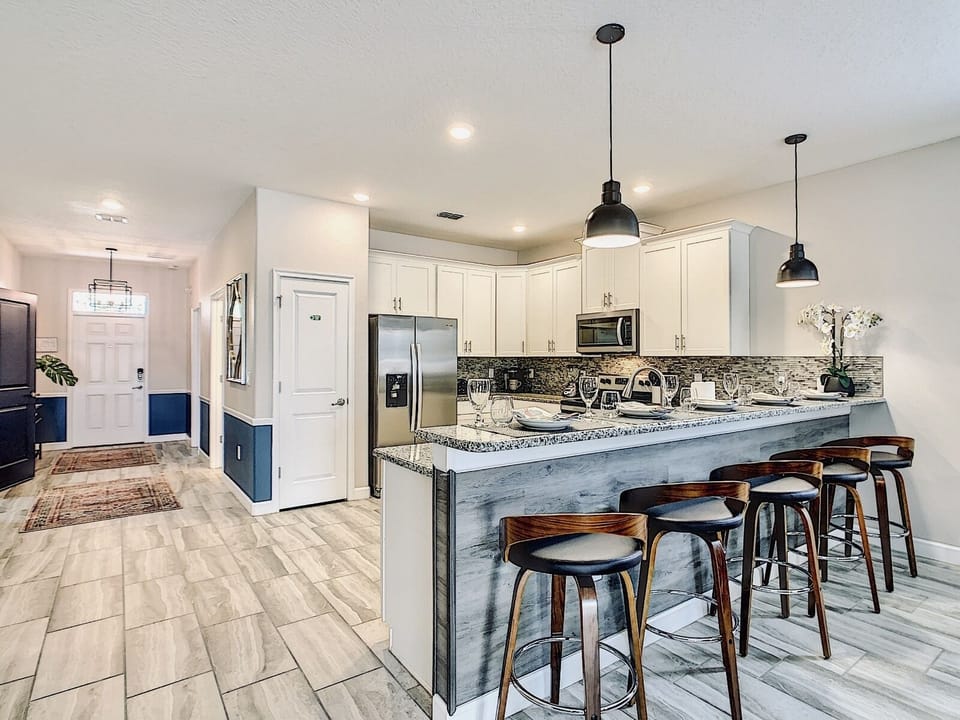 The countertop bar can comfortably seat 5 guests.