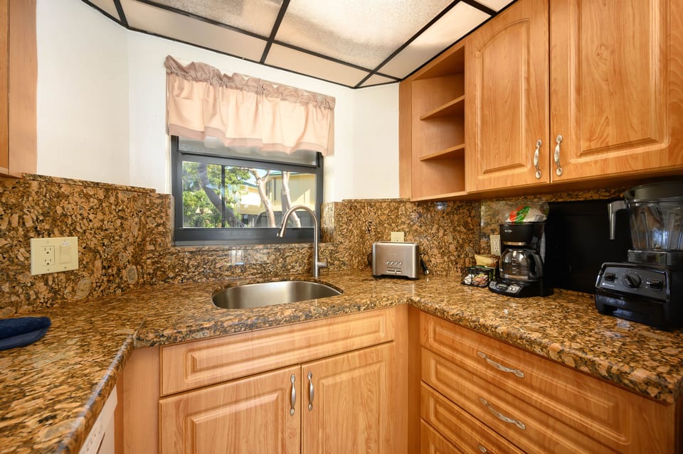 Kitchen pass thru to screened patio for dining in the tropical breeze