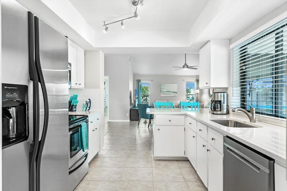 Stainless Steel Appliances and Glimmering White Quartz Countertops
