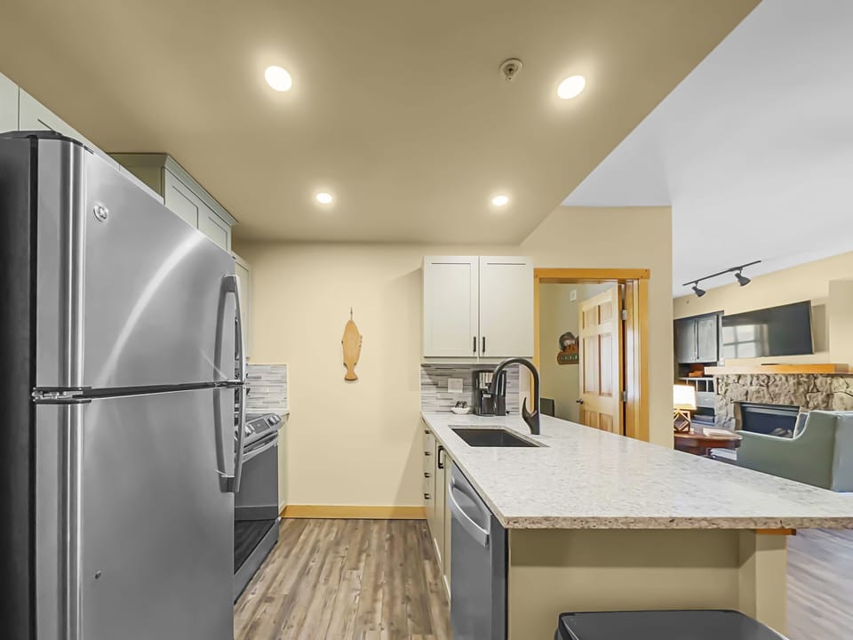 Modern kitchen with stainless steel appliances.