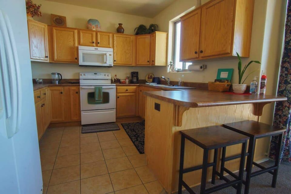 Fully stocked kitchen with cookware, dinnerware, refrigerator, stove, oven, microwave, dishwasher and various oils & spices for prepping meals as desired. There is a BBQ on the rear patio as well.