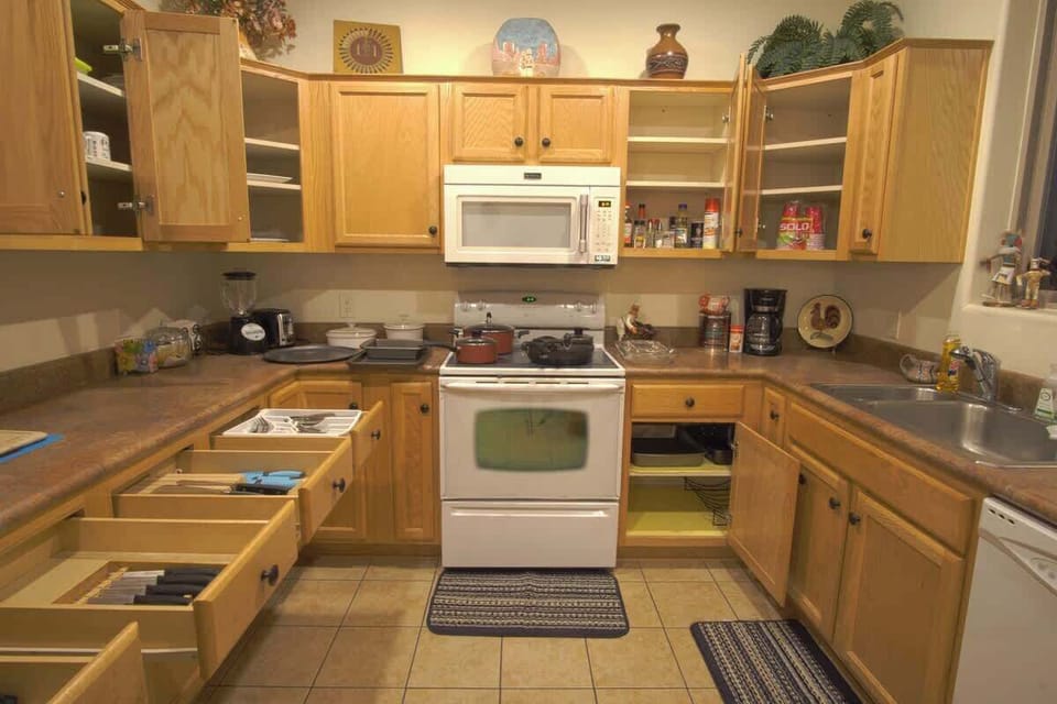Fully stocked Kitchen w/ oven, microwave, refrigerator/freezer, and dishwasher.  Rice Cooker, Crock Pot, Blender, Toaster, Coffee Maker, various pots, pans, glassware and utensils also included.