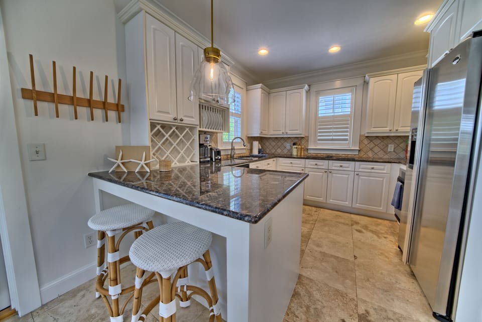 Beautiful chef's kitchen with eat on bar for two with bistro bar stools.