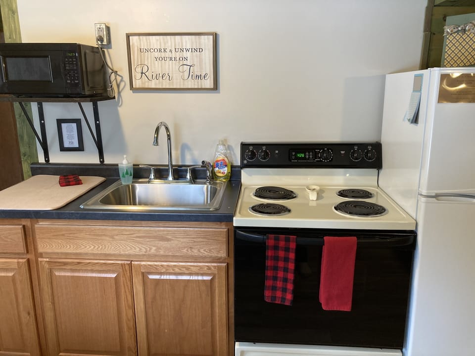 Coffee pot, toaster, microwave, stove, refrigerator and kitchen utensils 