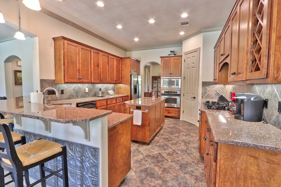 Bar seating surrounding the kitchen