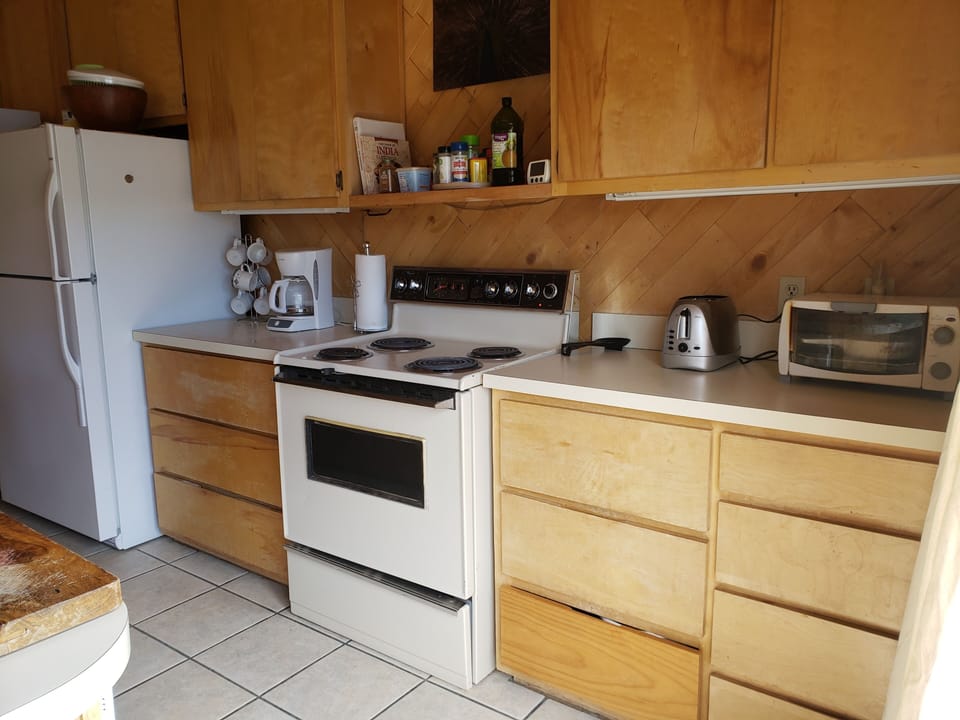 Large fridge, microwave, electric stove and oven, standard coffee maker, toaster