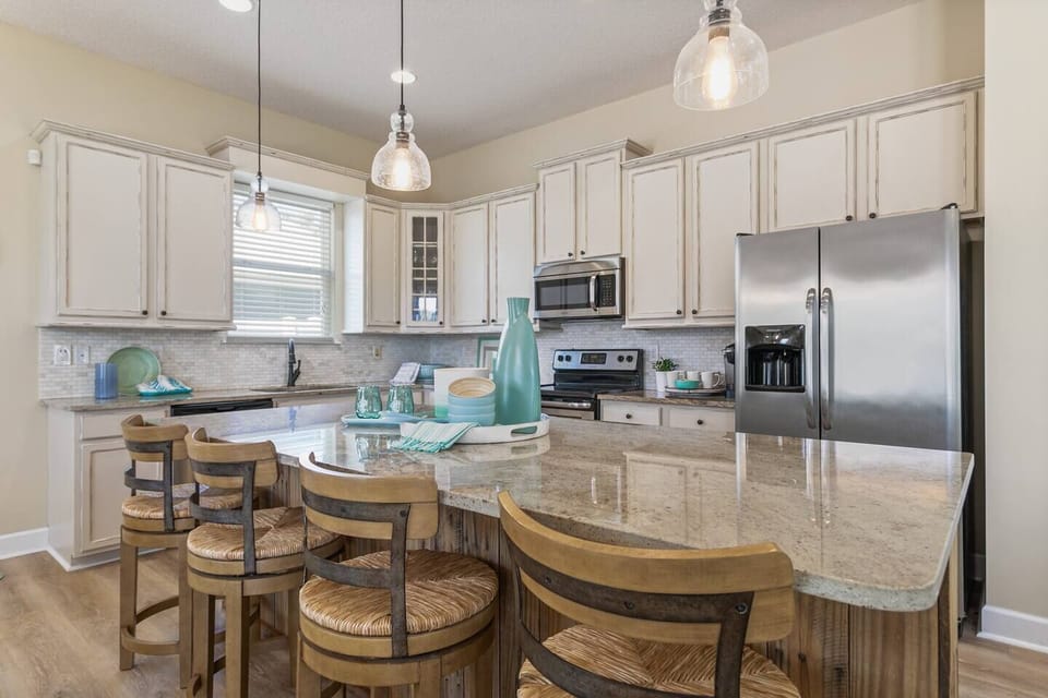 Spacious kitchen with island seating—ideal for coffee, cooking, and gathering together