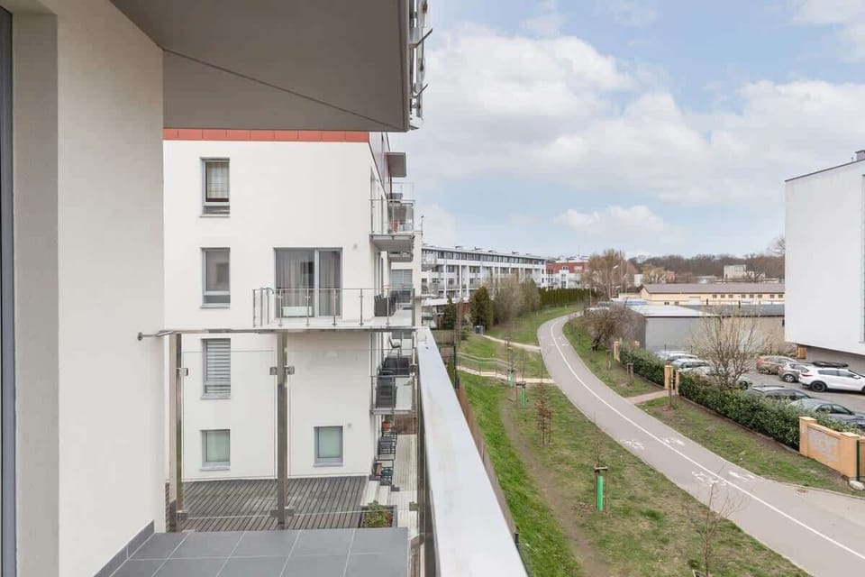 A different balcony view, showcasing the modern architecture of the building and the surrounding area.