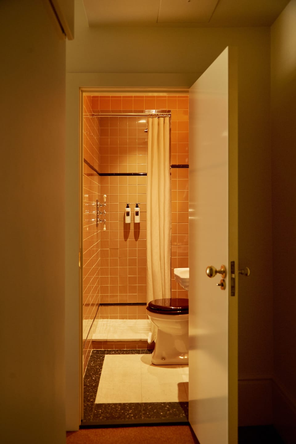 Designer toiletries, hair dryer, slippers, towels