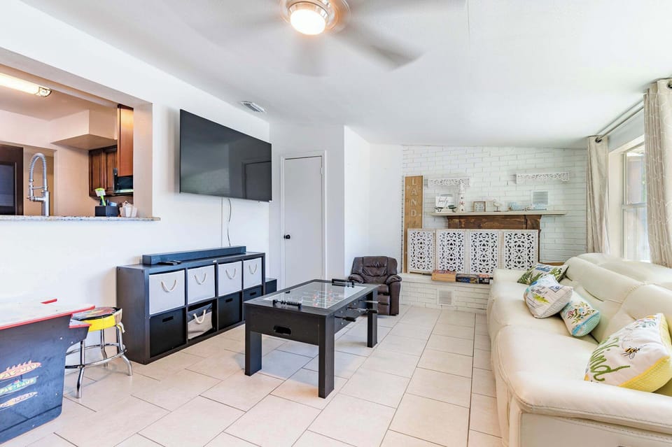More Space to Play! Relax on the comfortable couch or challenge a friend to a game of foosball. Includes a second large smart TV and stylish fireplace accent.