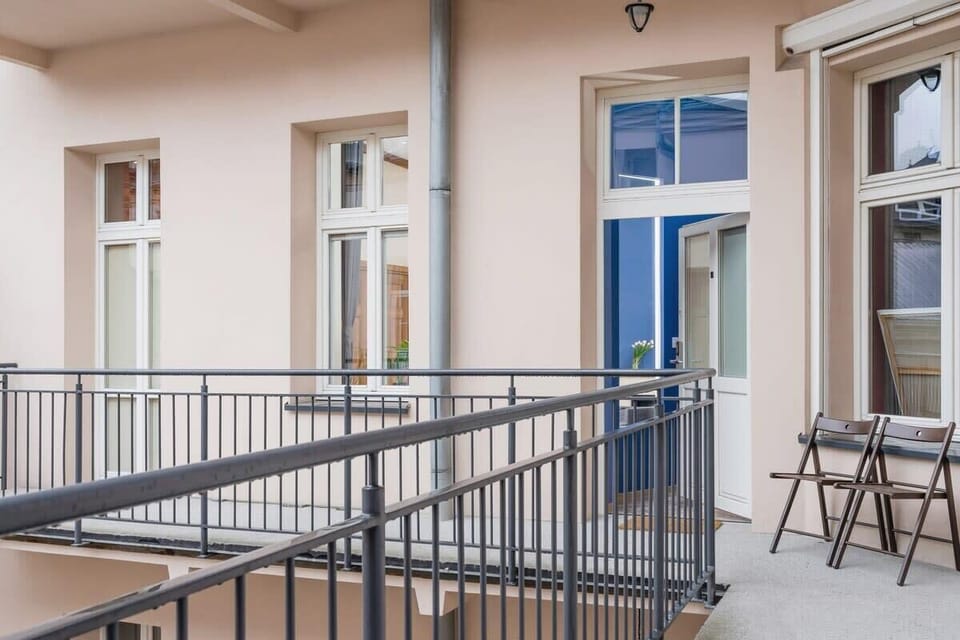 Spacious balcony with chairs that provide a place to spend time outdoors.