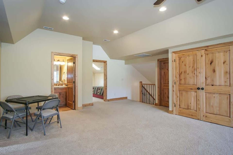 Upper level living room with view to stairs, game table, full bathroom.