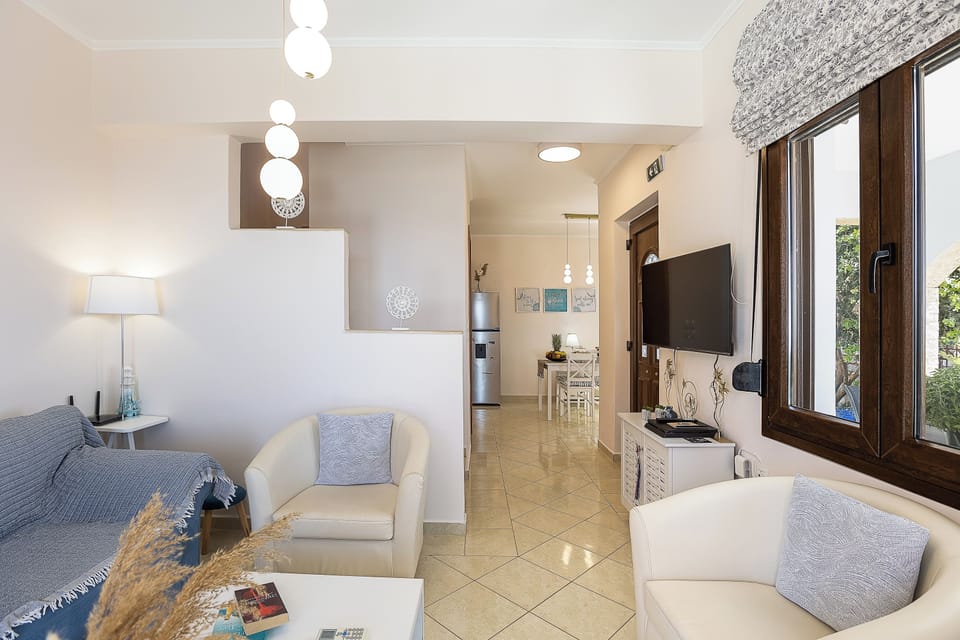 Light-filled living room with direct access to pool and garden views.