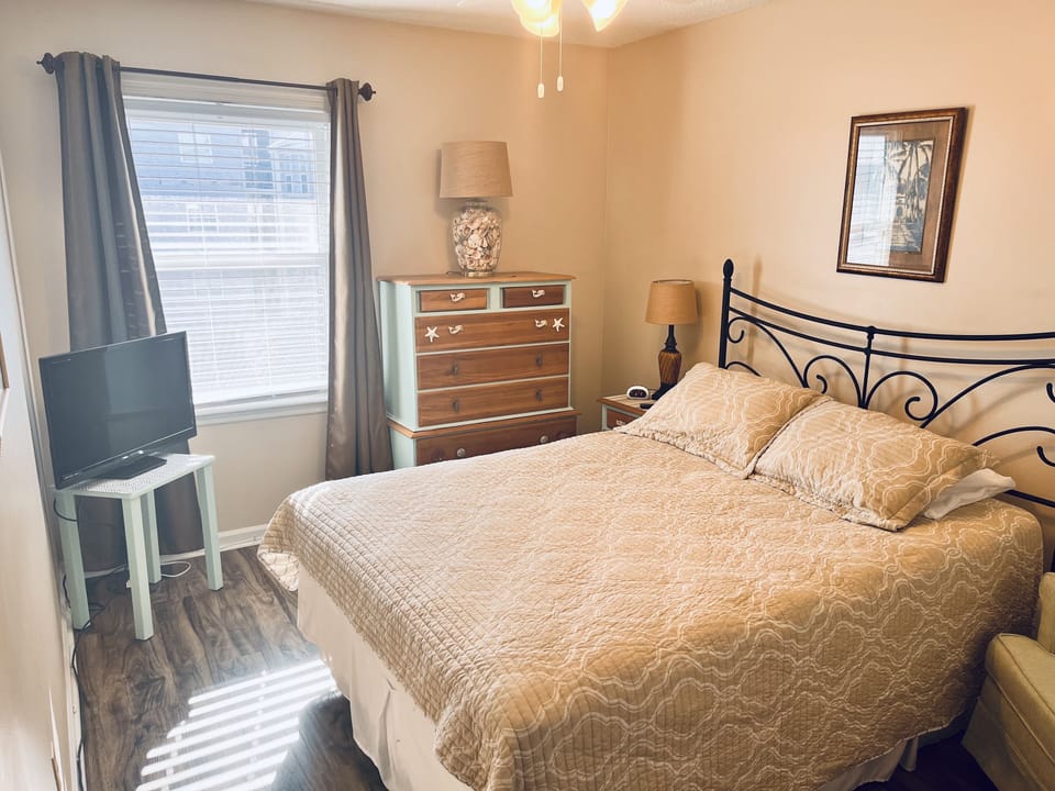 2nd bedroom queen bed and view of the pier
