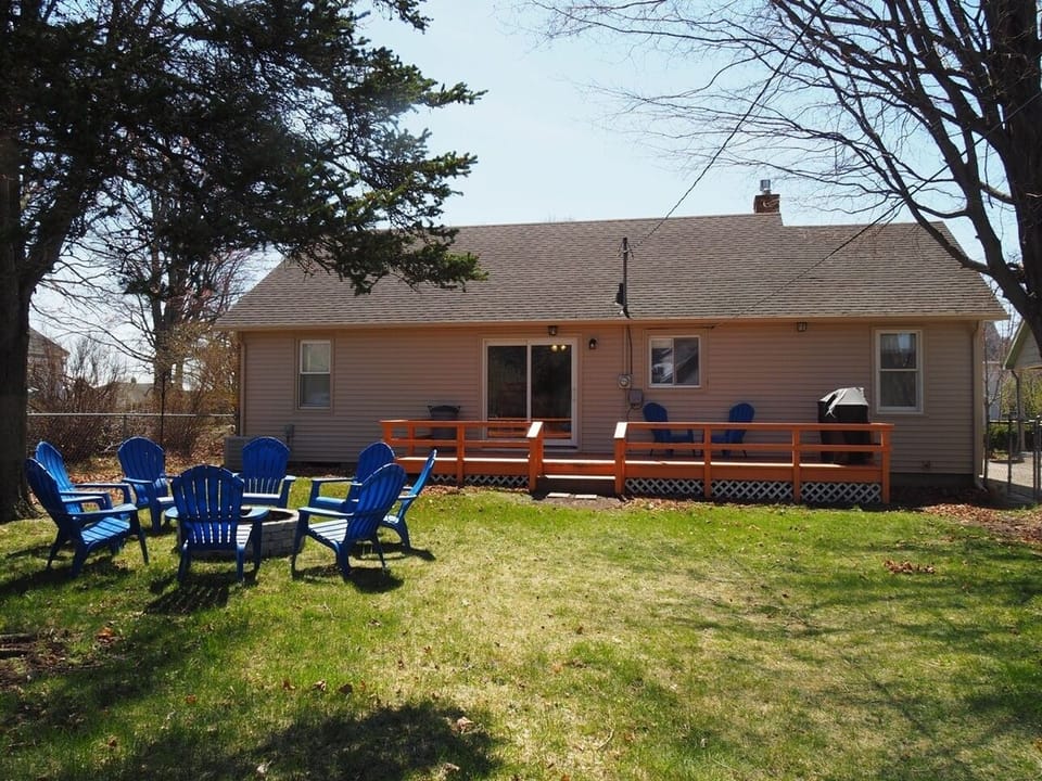 EXTERIOR:  Nice view of the backyard, including the back deck, gas grill, and fire pit.