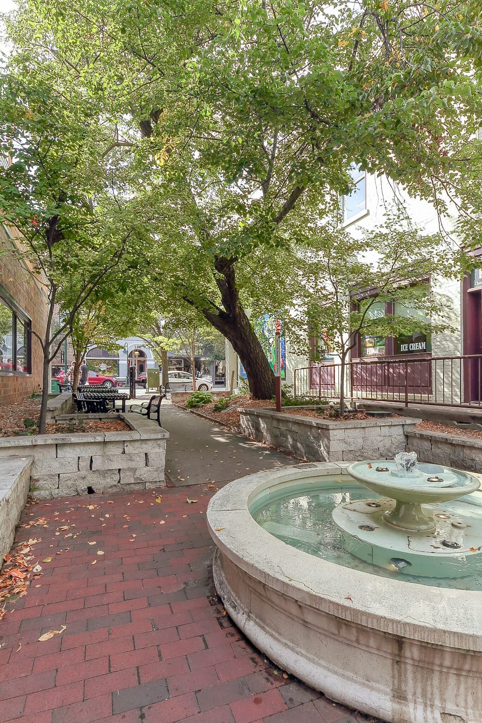 Tree-lined courtyard w/ fountain & benches for a peaceful outdoor break.