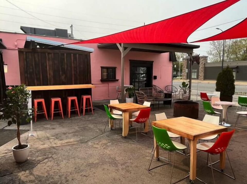 Casual outdoor patio w/ colorful seating & laid-back vibe