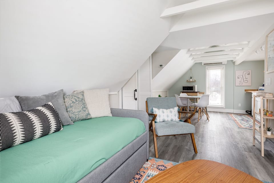 Bright loft-style living area w/ daybed, dining nook & vaulted ceilings for an airy, open feel.