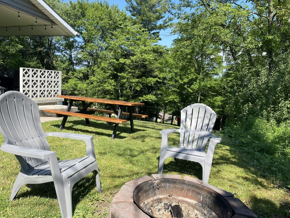Side yard offers a picnic table & and fire pit. 