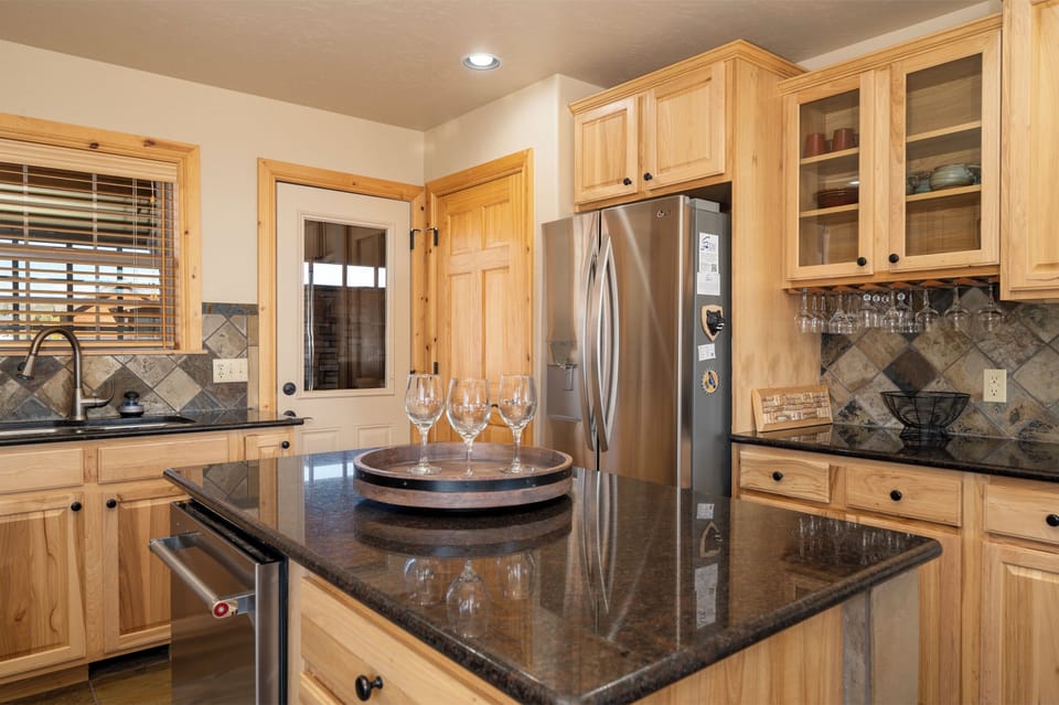 Your spacious kitchen features granite countertops, quality appliances, and warm wood cabinetry where you can prepare meals and gather with loved ones.
