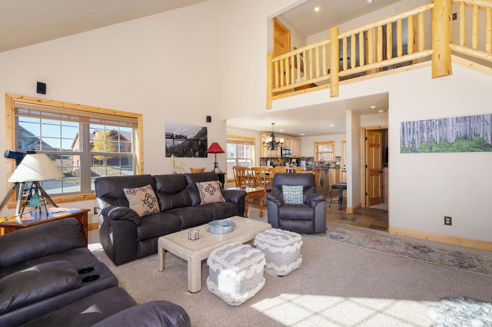 Sink into plush leather seating in your spacious living area, where soaring ceilings and natural light create the perfect gathering space.