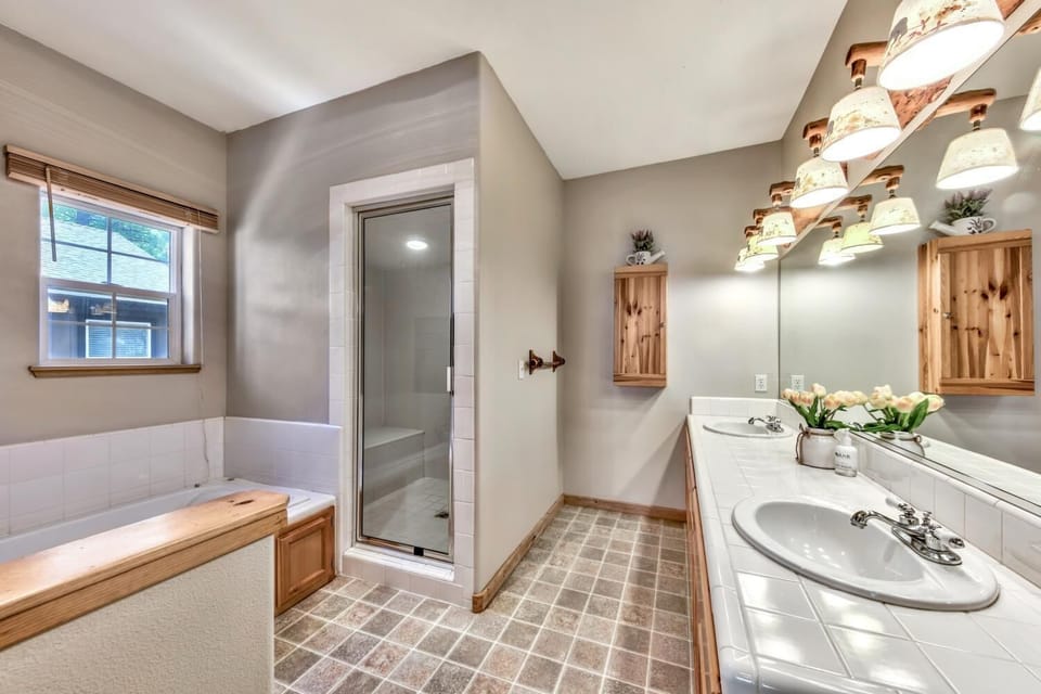Unwind in your private spa-like bathroom featuring a soaking tub, separate shower, and elegant finishes for ultimate relaxation.
