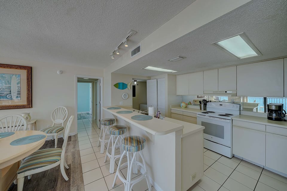 There is a dining table, perfect for enjoying a meal or playing a game, as well as additional breakfast bar seating.