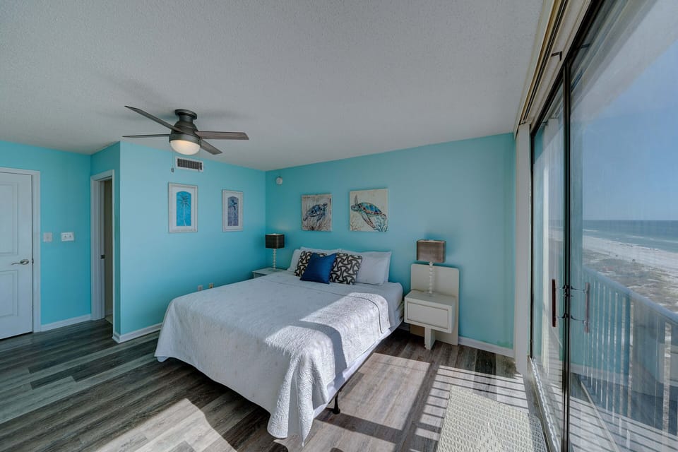The second bedroom also has a King-sized bed, a television, & more floor-to-ceiling gulf views.