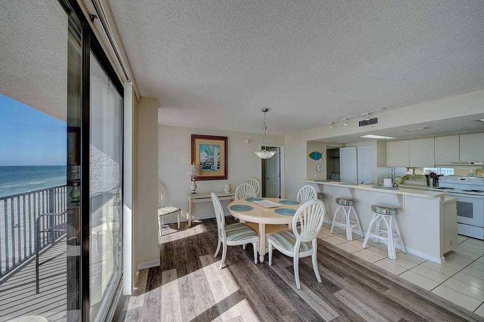 There is a dining table, perfect for enjoying a meal or playing a game, as well as additional breakfast bar seating.