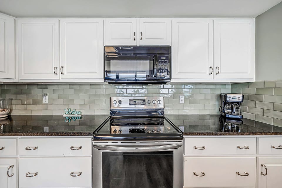 The fully equipped kitchen has everything you need to prepare meals for family & friends. It features granite countertops, stainless-steel appliances, and beautiful subway tile backsplash.