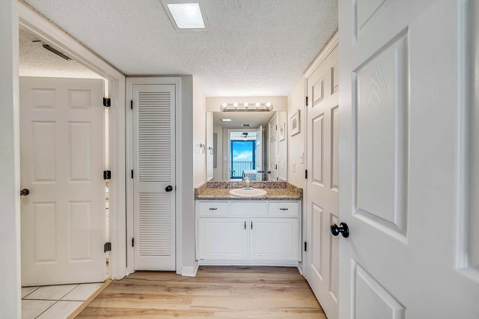The ensuite master bathroom features granite countertops and a separate dressing area.