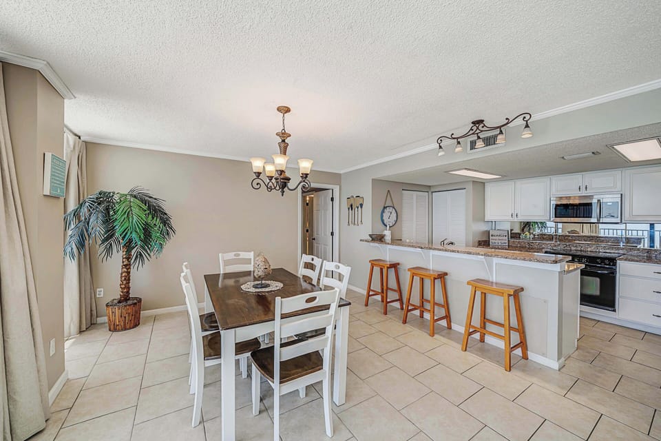 There is a dining table, perfect for enjoying a meal or playing a game, as well as additional breakfast bar seating.