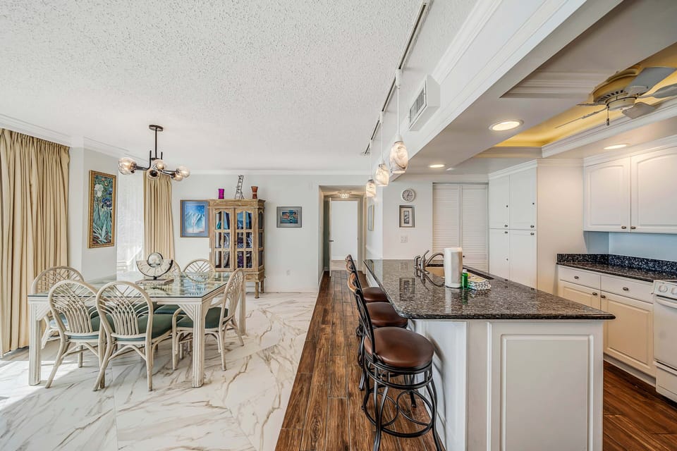 There is a dining table that seats 6, perfect to enjoy a meal or play a game, as well as additional breakfast bar seating.